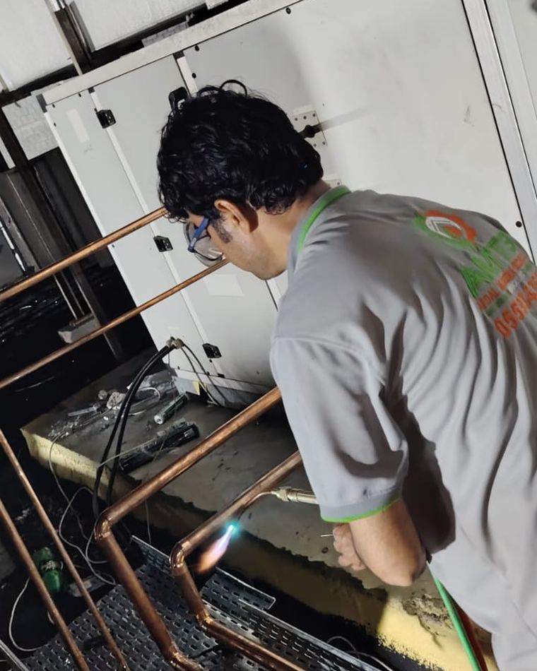 AMTS technician brazing refrigerant copper piping on a Dubai site